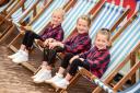 Alice Morgan, four, with sisters Emilia, six and Lillie, eight making castles in the sand