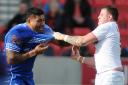 Samoa's Mose Masoe and England Knights' Brad Singleton come to blows in Saturday's clash at Salford. Picture by Mike Boden