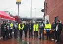 Councillors, police officers, and safety marshals in Leigh town centre