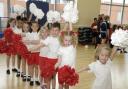 2, 4, 6, 8... pupils from Leigh St John’s Infants wave their pom poms