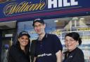 Tom Watson (centre) has managed  the William Hill shop in Hoylake since 2009.
