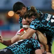 Leigh Leopards make a tackle  at Hull KR