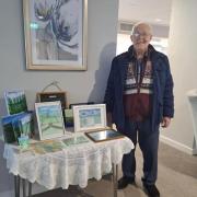 Brian with his paintings at Wharfdale Estate