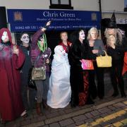 Members of Manchester People’s Assembly holding a Halloween-inspired protest outside Atherton MP Chris Green’s office