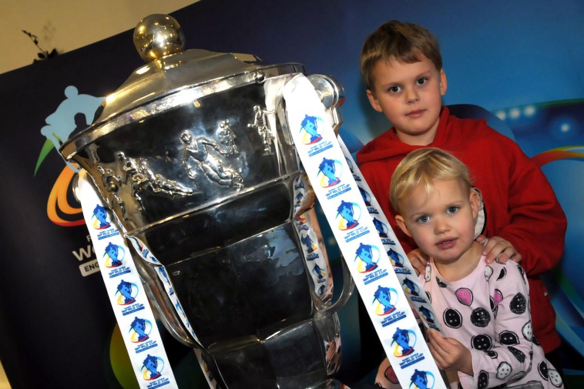 Arron and Amelie Lindop, aged five and two, with the  World Cup trophy when it visited The Halliwell Jones Stadium