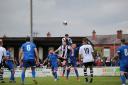 Atherton Colls’ Josh Thompson jumps the highest in the game against FC United of Manchester. Pic: David Featherstone