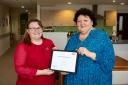 Jemma Sharratt, village nurse manager at Belong Atherton, is presented with her award by Professor Deborah Sturdy CBE, chief nurse for adult social care in England.
