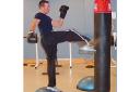 Left: Mark Brown using a Bosu for kick boxing. Right: Julie Burfoot doing stomach exercises on a Bosu
