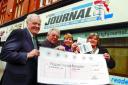 CHEQUE-MATES: Edwin Matthews from Wigan and Leigh Hospice receives the cheque from Ronnie Carr, Winifred Brierley and Journal columnist Lesley Richard