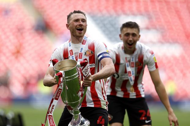 Corry Evans with the League One play-off final trophy