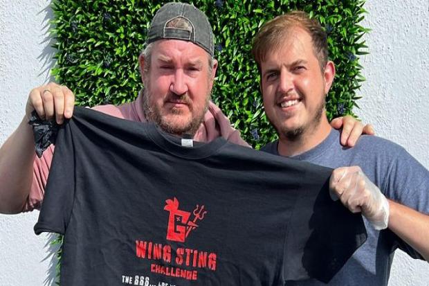 Manager of Jus' Winging It Joe Pybus (right) with the first winner of the 'Wing Sting' challenge Damien - Credit: Joe Pybus