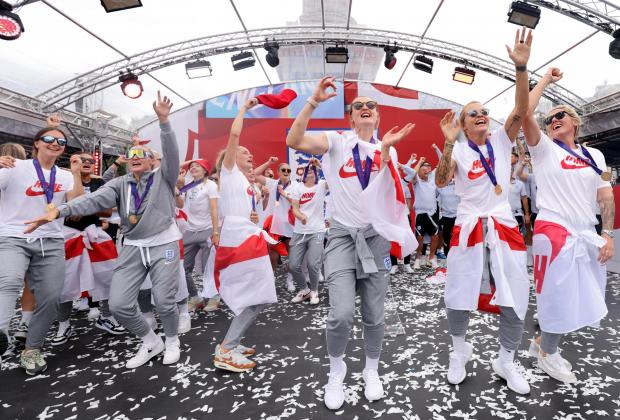 Leigh Journal: England players sing Sweet Caroline on stage during a fan celebration to commemorate England's historic UEFA Women's EURO 2022 triumph in Trafalgar Square. Credit: PA