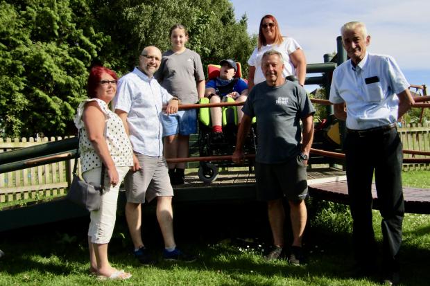 Louise Molyneux-Rogers with son Dylan, 20, and daughter Alannah, 11, at Sutton Weaver playground with (L to R) parish clerk Tracey Whitlow and parish councillors Simon Richards, Tony Spencer and Brian Starkey.