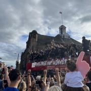 Leigh Leopards celebrating the Challenge Cup trophy from the open top bus