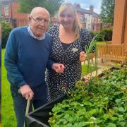 Resident, Bill Dootson, and experience coordinator, Kim Calland, enjoy the results of their gardening