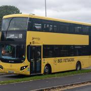 A yellow V1 bus in Leigh