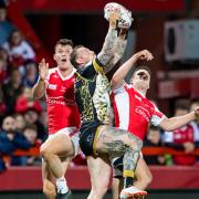 Josh Charnley leaps for the ball